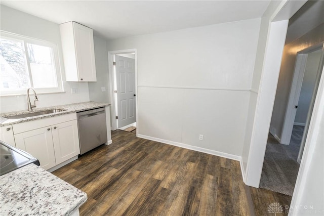 kitchen with stainless steel dishwasher, a sink, white cabinetry, and light stone countertops