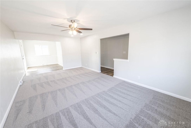 empty room featuring ceiling fan, carpet flooring, and baseboards