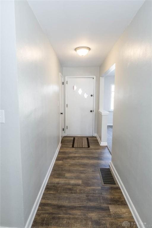 doorway with visible vents, dark wood finished floors, and baseboards