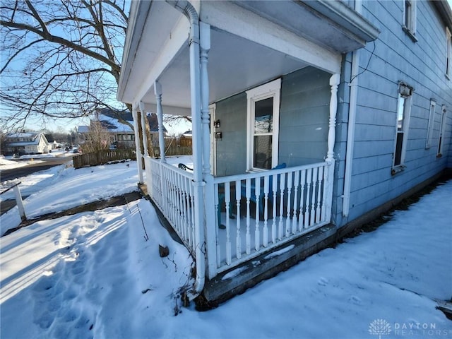 view of snow covered exterior with a porch