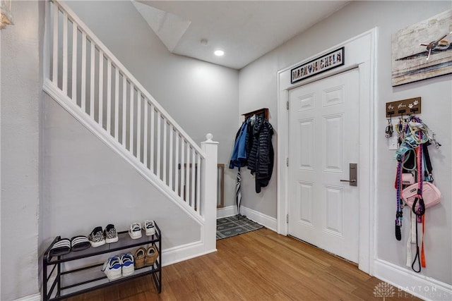 foyer entrance featuring stairway, recessed lighting, wood finished floors, and baseboards