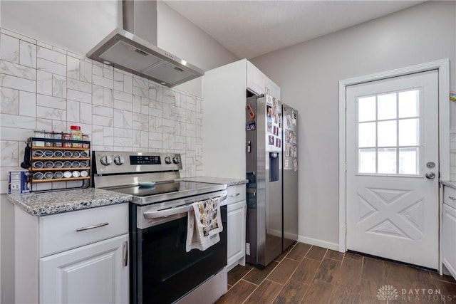 kitchen with appliances with stainless steel finishes, light stone counters, wood tiled floor, extractor fan, and white cabinetry