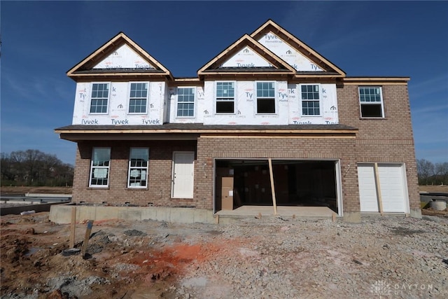 view of front of house with brick siding and a garage