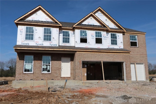 property in mid-construction with brick siding and a garage