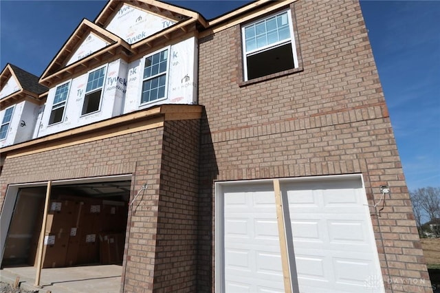 exterior space with brick siding and a garage