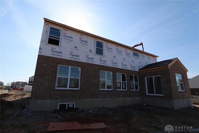 view of side of property featuring brick siding