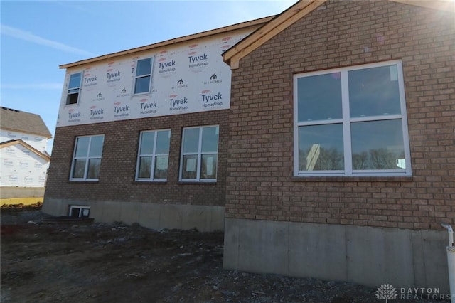 view of side of property with brick siding