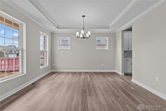 2881 Sky Crossing Dr Unit 55, Beavercreek, OH 45434 - unfurnished dining area with a tray ceiling, a chandelier, crown molding, light wood finished floors, and baseboards