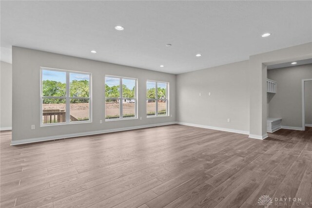 2881 Sky Crossing Dr Unit 55, Beavercreek, OH 45434 - unfurnished living room with wood finished floors, recessed lighting, and baseboards