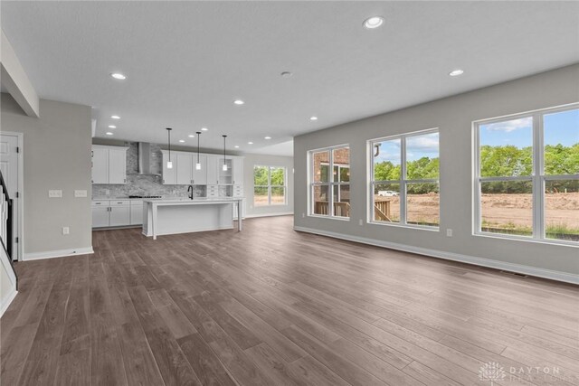 2881 Sky Crossing Dr Unit 55, Beavercreek, OH 45434 - unfurnished living room with recessed lighting, dark wood-type flooring, baseboards, and a sink