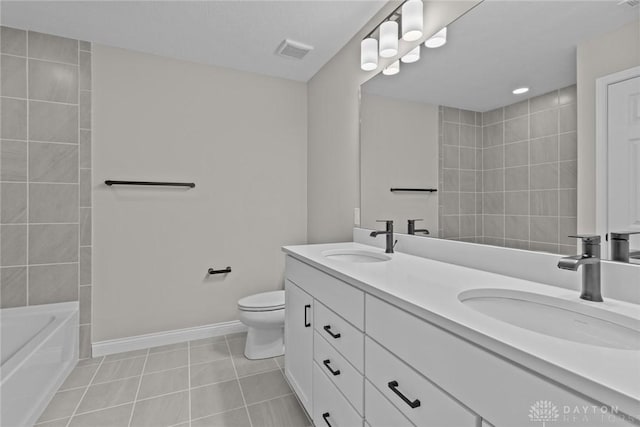 2881 Sky Crossing Dr Unit 55, Beavercreek, OH 45434 - bathroom featuring tile patterned floors, toilet, baseboards, a tub, and double vanity