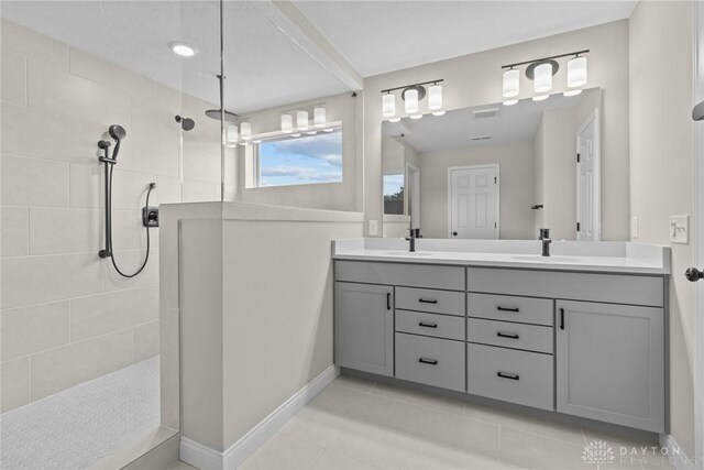 2881 Sky Crossing Dr Unit 55, Beavercreek, OH 45434 - bathroom with double vanity, a walk in shower, baseboards, and tile patterned floors