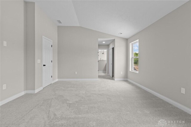 2881 Sky Crossing Dr Unit 55, Beavercreek, OH 45434 - carpeted empty room featuring vaulted ceiling and baseboards