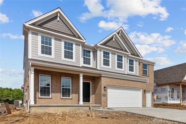 2881 Sky Crossing Dr Unit 55, Beavercreek, OH 45434 - view of front facade featuring a garage, driveway, cooling unit, and brick siding