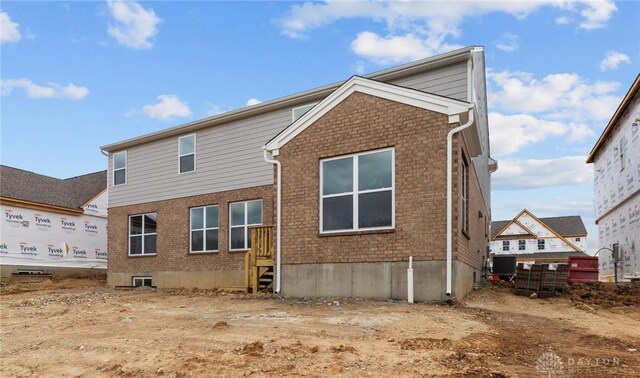 2881 Sky Crossing Dr Unit 55, Beavercreek, OH 45434 - back of property featuring brick siding and central AC unit