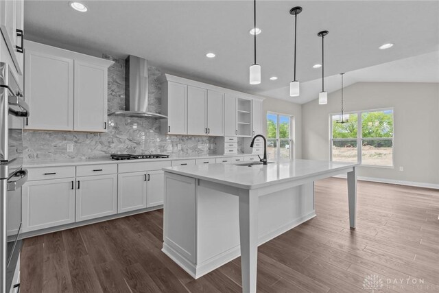 2881 Sky Crossing Dr Unit 55, Beavercreek, OH 45434 - kitchen featuring wall chimney exhaust hood, a sink, light countertops, lofted ceiling, and backsplash