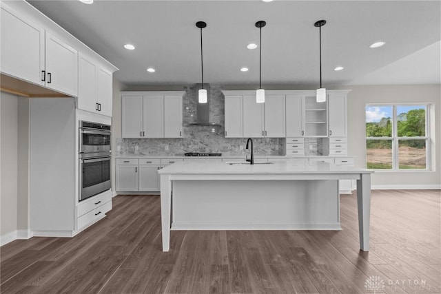 2881 Sky Crossing Dr Unit 55, Beavercreek, OH 45434 - kitchen featuring wall chimney exhaust hood, a sink, gas cooktop, stainless steel double oven, and decorative backsplash