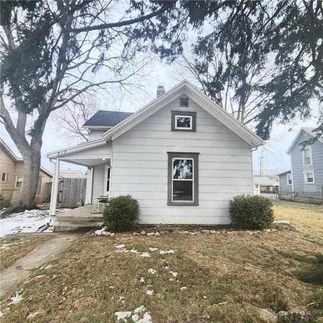 bungalow-style house with fence