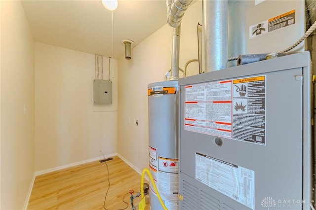 utility room featuring gas water heater, electric panel, and heating unit