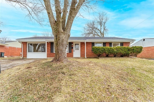 single story home with a front yard and brick siding