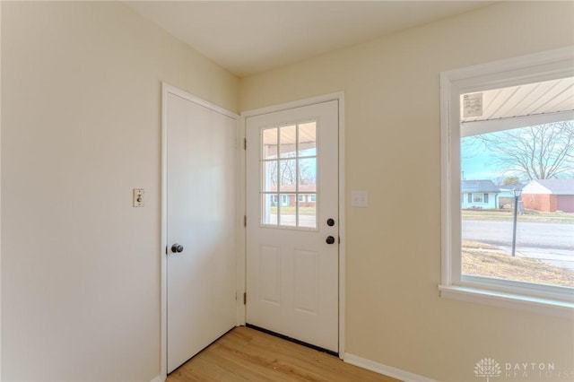 entryway featuring light wood-type flooring and baseboards