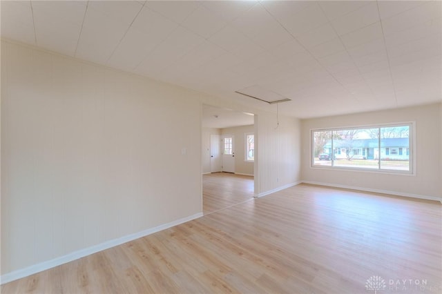 spare room featuring light wood-style flooring and baseboards