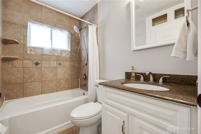 bathroom featuring shower / bath combination with curtain, visible vents, vanity, and toilet