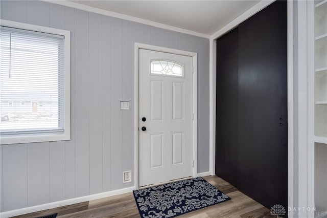 entrance foyer featuring wood finished floors and crown molding