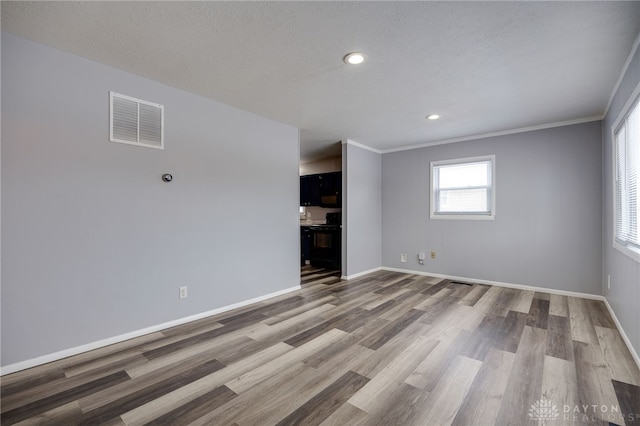 empty room featuring recessed lighting, visible vents, baseboards, and wood finished floors