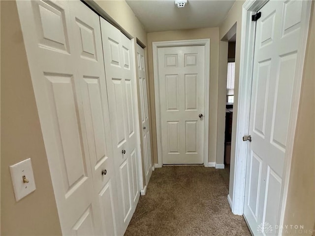 hall with carpet and baseboards