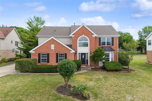 view of front of property with brick siding and a front yard