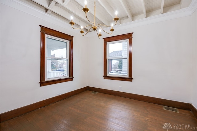 unfurnished room with beamed ceiling, wood finished floors, visible vents, and baseboards