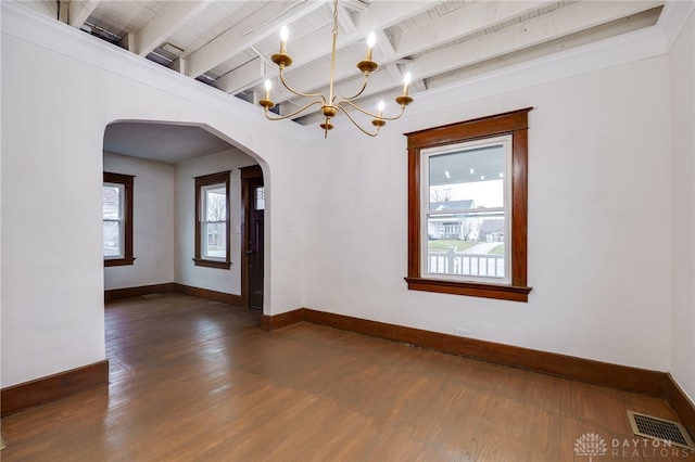 spare room featuring arched walkways, a chandelier, dark wood-type flooring, visible vents, and beam ceiling