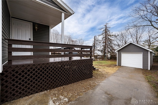 exterior space with a garage, driveway, and an outdoor structure