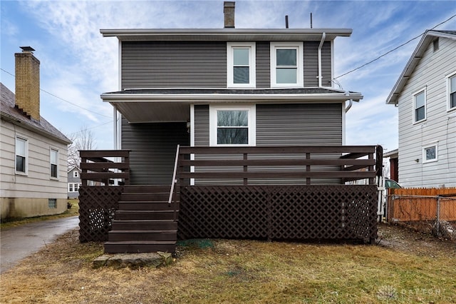 back of property featuring fence and a yard