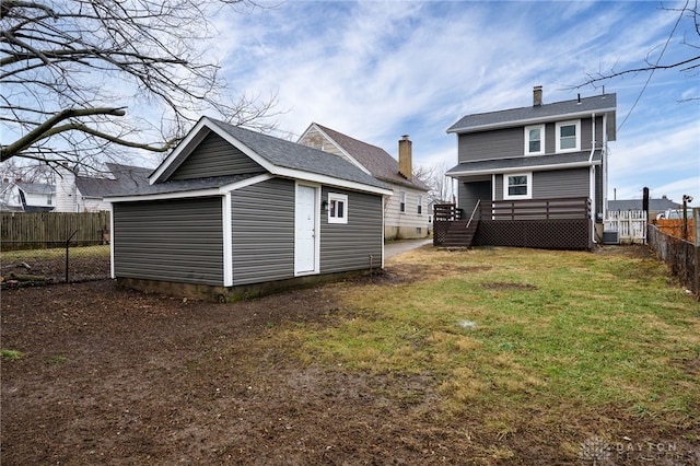 exterior space with a fenced backyard, a lawn, and a wooden deck