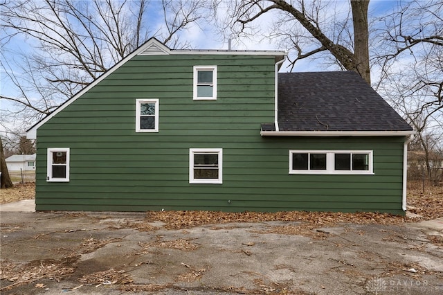 view of home's exterior with roof with shingles