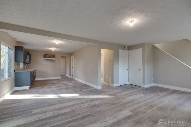 unfurnished living room featuring baseboards and light wood-style floors