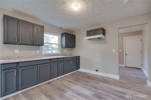 kitchen with light wood-style floors, baseboards, and light countertops