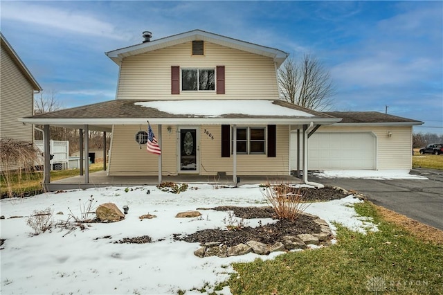 view of front facade with covered porch, aphalt driveway, and an attached garage