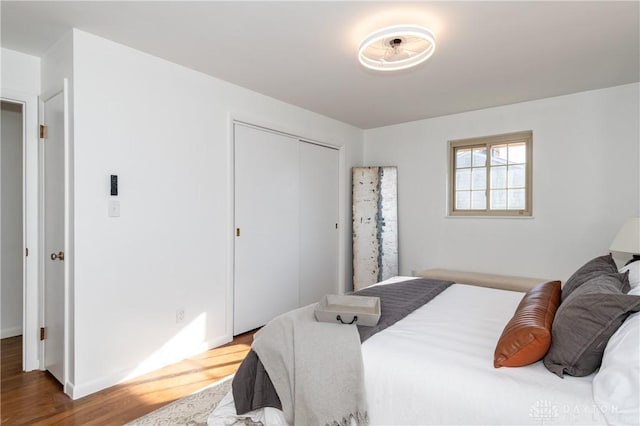 bedroom featuring a closet and wood finished floors