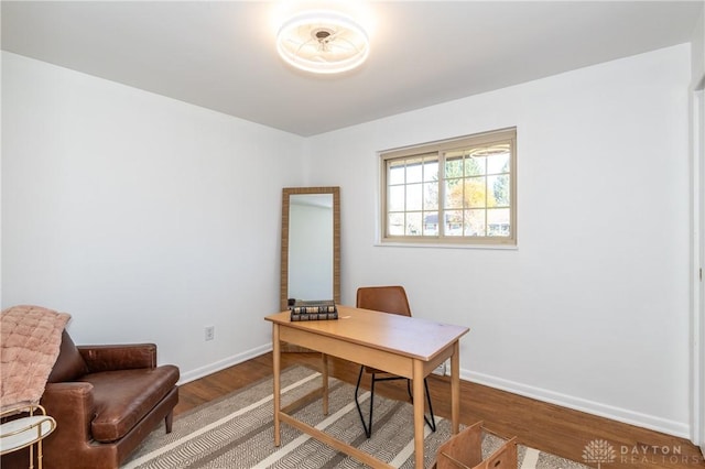 home office with wood finished floors and baseboards