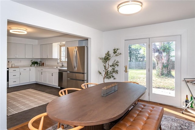 dining room with plenty of natural light and dark wood-type flooring