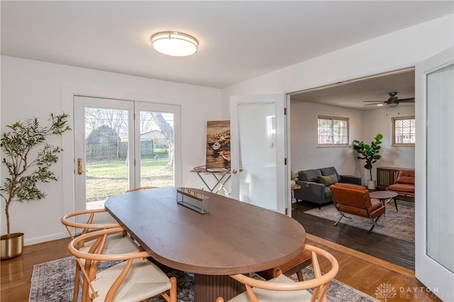 dining space with baseboards and dark wood-type flooring