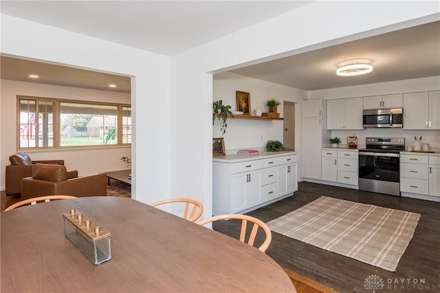 dining room with dark wood-style floors and recessed lighting