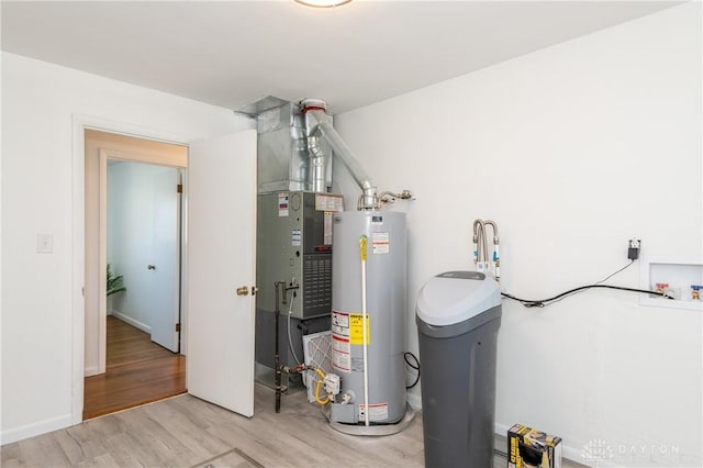 utility room featuring water heater