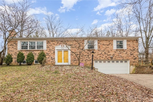 view of front of house featuring a garage, driveway, brick siding, and a chimney