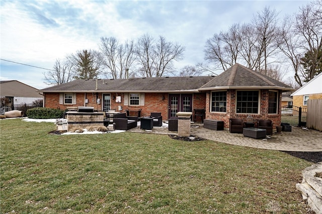 back of house with outdoor lounge area, a patio, brick siding, and fence