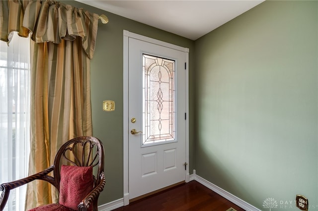 foyer entrance featuring dark wood-style floors and baseboards