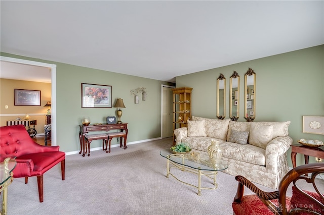 living room featuring baseboards and light colored carpet